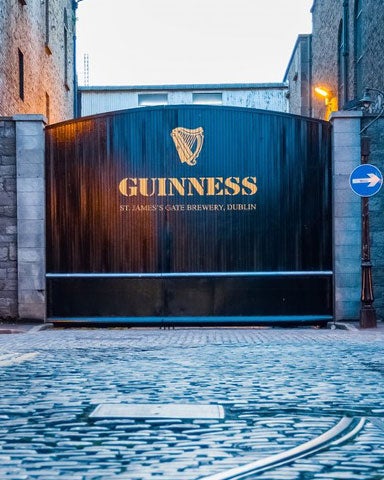 The Guinness Storehouse entrance with large gates and cobbled street