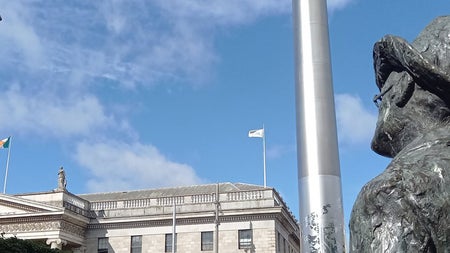 James Joyce statue in Dublin looking towards a stately building in Dublin