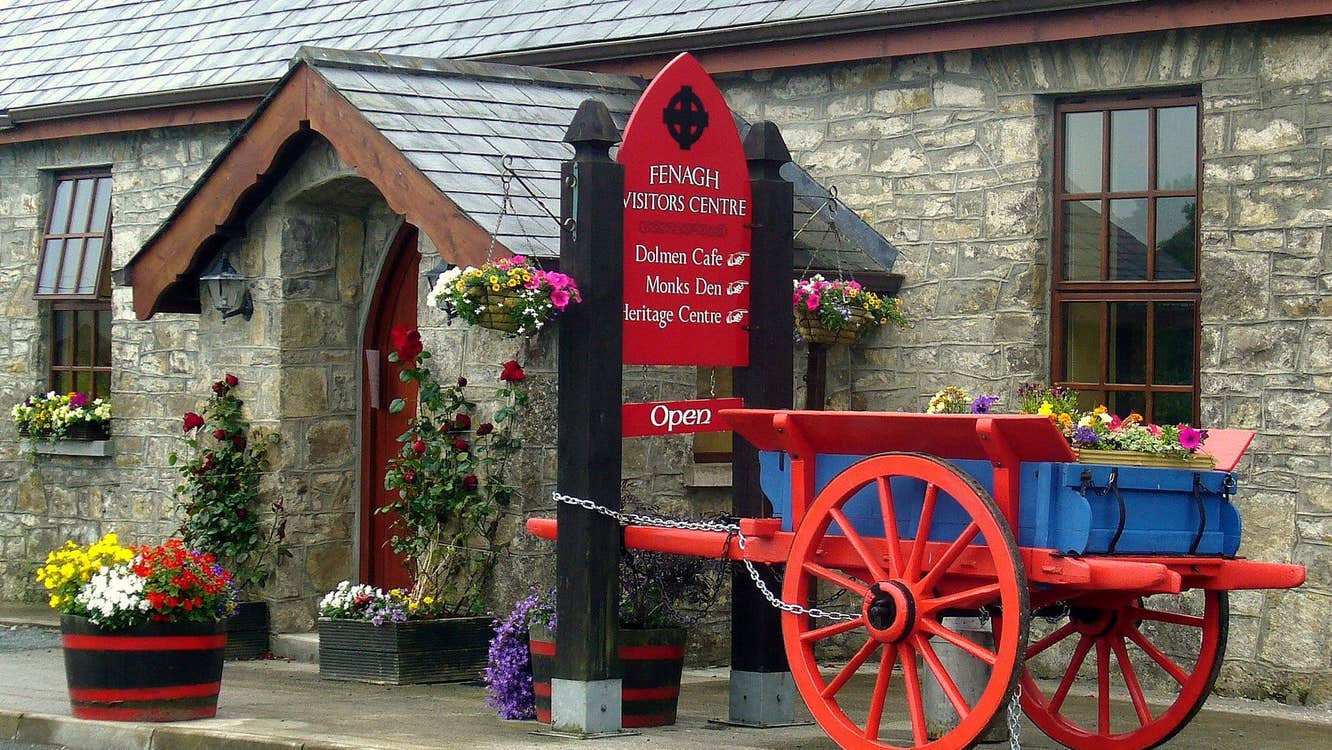 A red and blue painted horse cart outside the Fenagh Visitor Centre