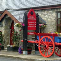A red and blue painted horse cart outside the Fenagh Visitor Centre