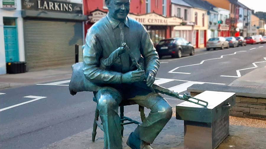 A statue of Willie Clancy playing the uilleann pipes