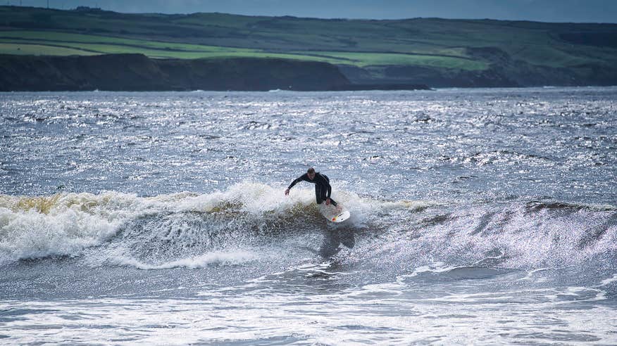 A surfer at Lahinch Beach in Co Clare