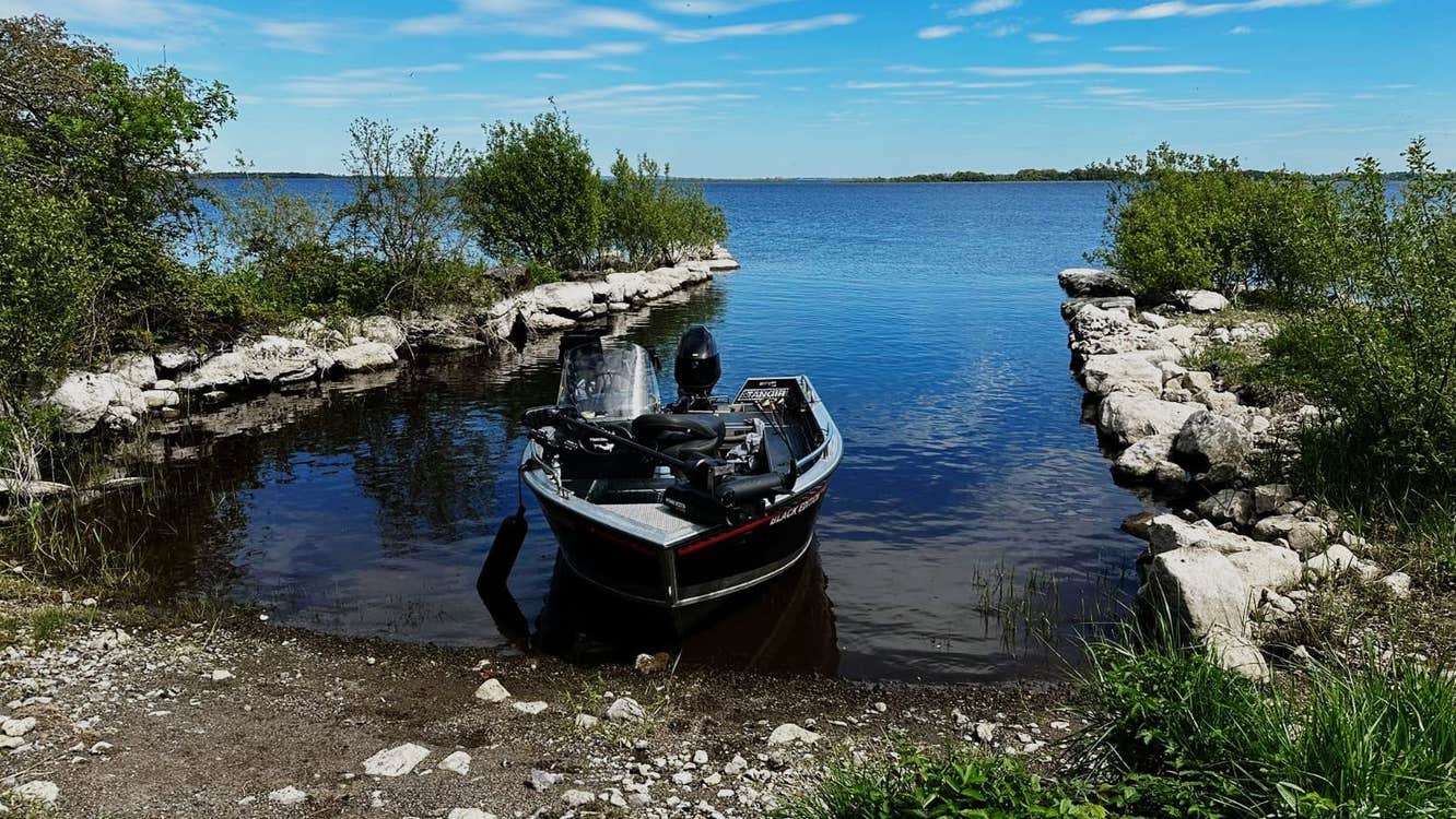 A fishing boat on the shores of Lough Ree with Brick Island Angling