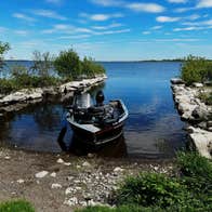 A fishing boat on the shores of Lough Ree with Brick Island Angling