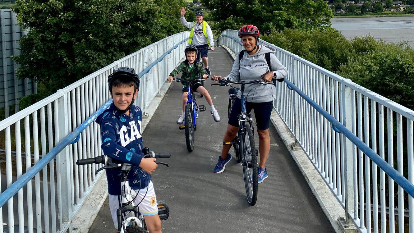 Family on a narrow bridge with their bikes