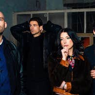 Group of 3 men and a woman all looking thoughtful in different directions