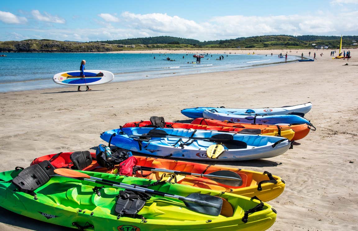 Colourful kayaks on the sand at Marble Hill Beach, Co Donegal