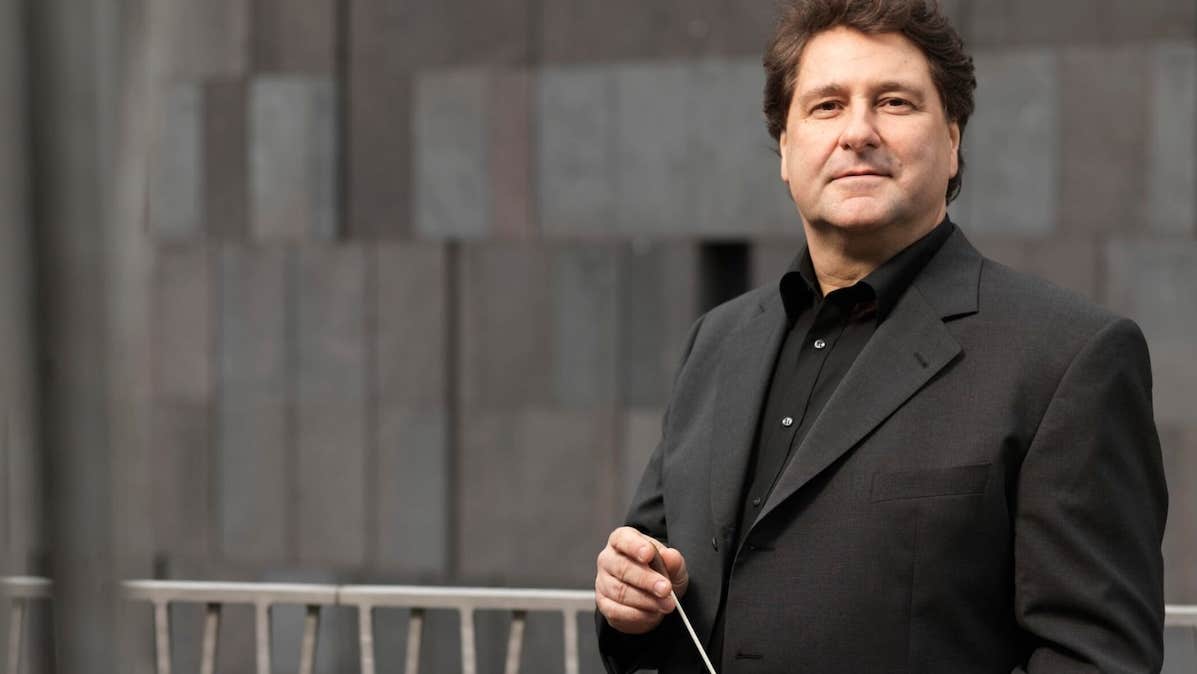 Johannes Widler, conductor - a man in dark jacket and shirt holding a baton.