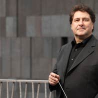 Johannes Widler, conductor - a man in dark jacket and shirt holding a baton.