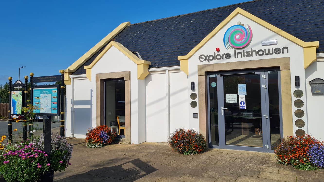 An image of the Inishowen Community Tourist Office exterior with an information board