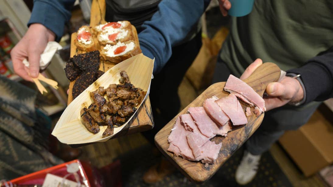 People enjoying plates of meat on a Teacht Linn Food Tours, Milk Market Limerick