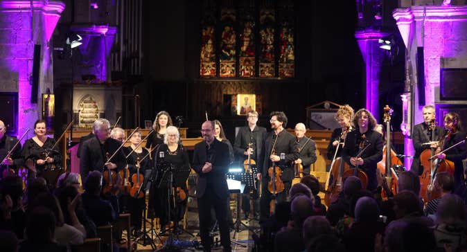 The Luminosa String Orchestra standing after their performance at St Nicholas' Collegiate Church, Galway