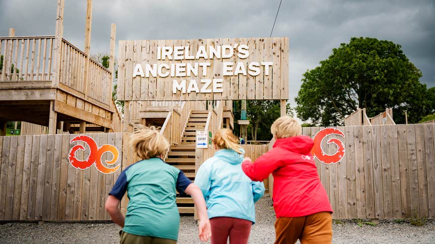 Three kids running to the maze at Skypark in Carlingford Adventure Centre in County Louth