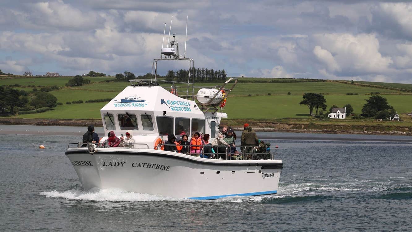 A fishing vessel at sea carrying passengers