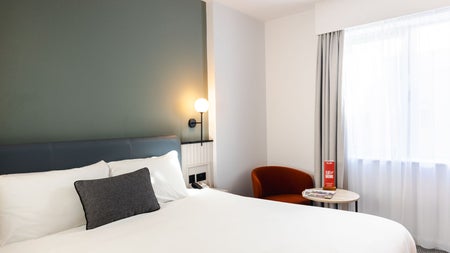 Double bed with white sheets