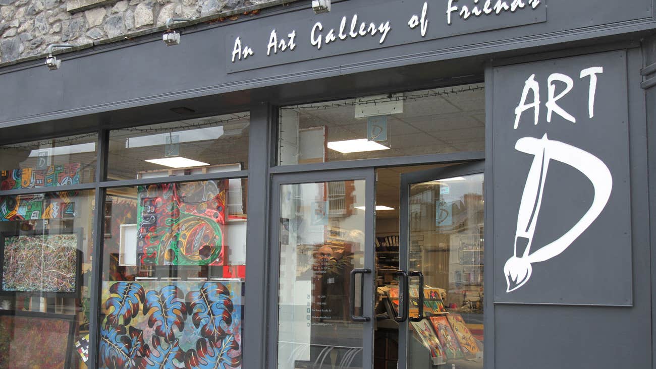 Exterior view of ArtD Gallery with art on display in the window