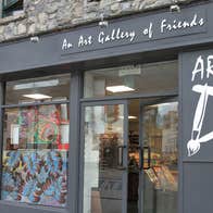 Exterior view of ArtD Gallery with art on display in the window 