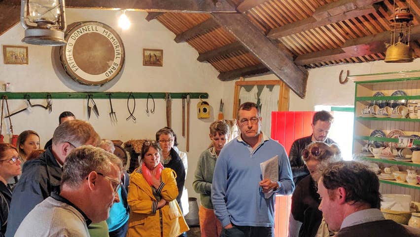 Gael Linn Irish Language Classes for Adults group visiting a traditional cottage