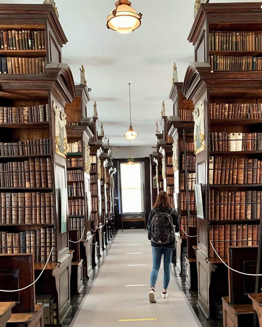 Image of a person walking through Marsh's Library in Dublin.