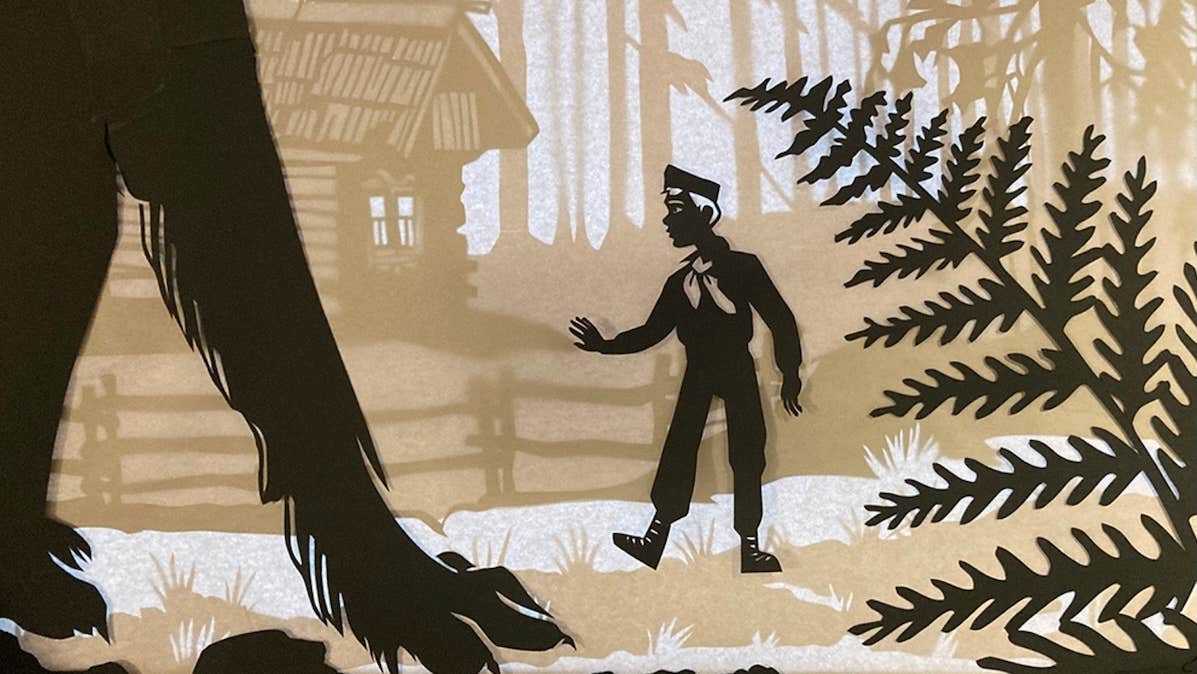 Peter and the Wolf with the NSOI, black, beige and white image of a wolf's large forelegs and a boy against a cabin and woods.