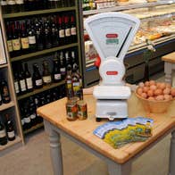 A scales and grocery items in Benny's Deli