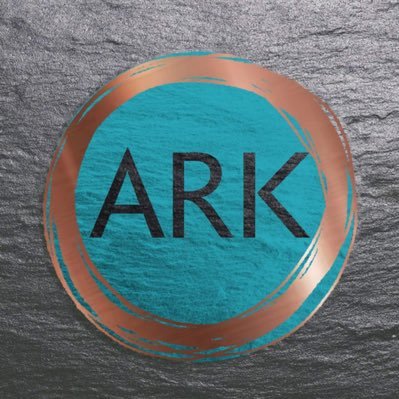 Logo of Ark Storytelling Festival, black writing on teal coloured background surrounded by brass coloured circle border on grey, stoney effect background.