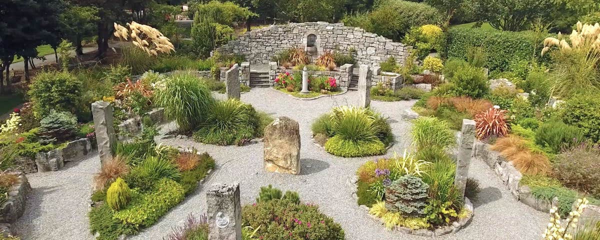 Gravel pathways meander through standing stones and shrubbery