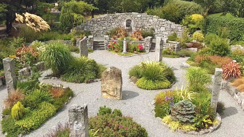 Gravel pathways meander through standing stones and shrubbery