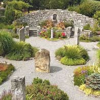Gravel pathways meander through standing stones and shrubbery