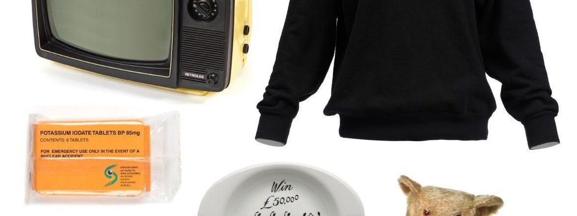 A group of random items against a white background including a teddy bear, a ashtray and an old portable TV