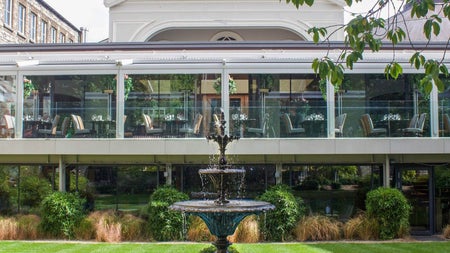 A Victorian style water fountain in front of the outdoor terrace