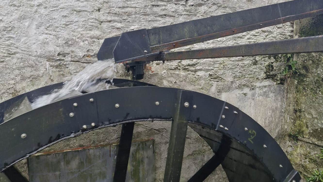 Water flowing into a metal mill wheel