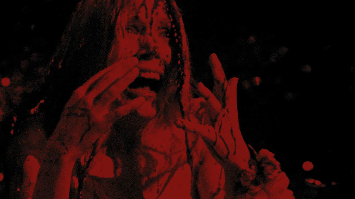 A dark figure in red is screaming with hands held up to their face.