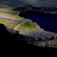 Aerial view of Dun Ducathair Fort on cliff edge of Inishmore Aran Islands