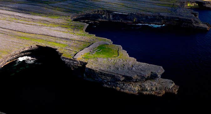 Aerial view of Dun Ducathair Fort on cliff edge of Inishmore Aran Islands