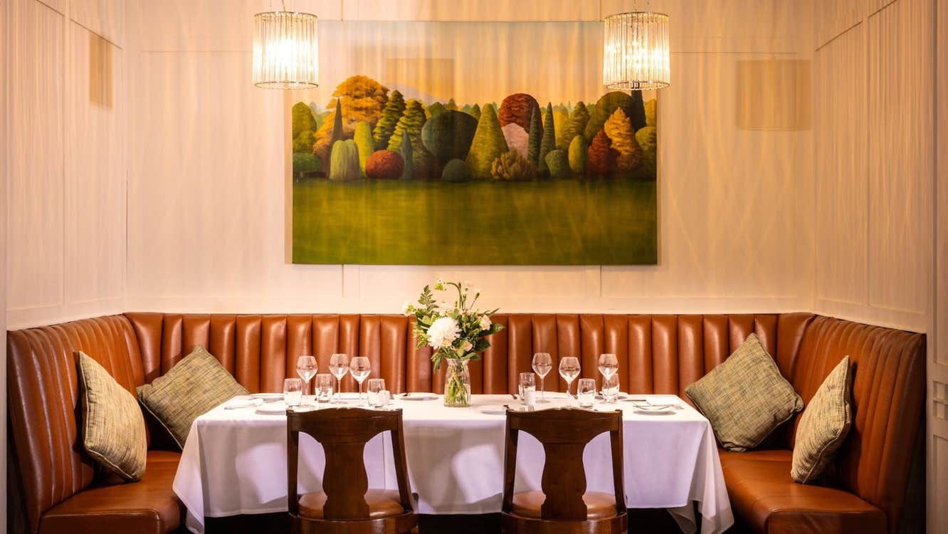 Leather corner seating area with a table prepared for dining