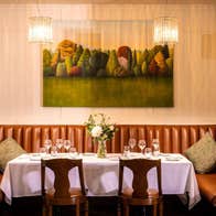 Leather corner seating area with a table prepared for dining