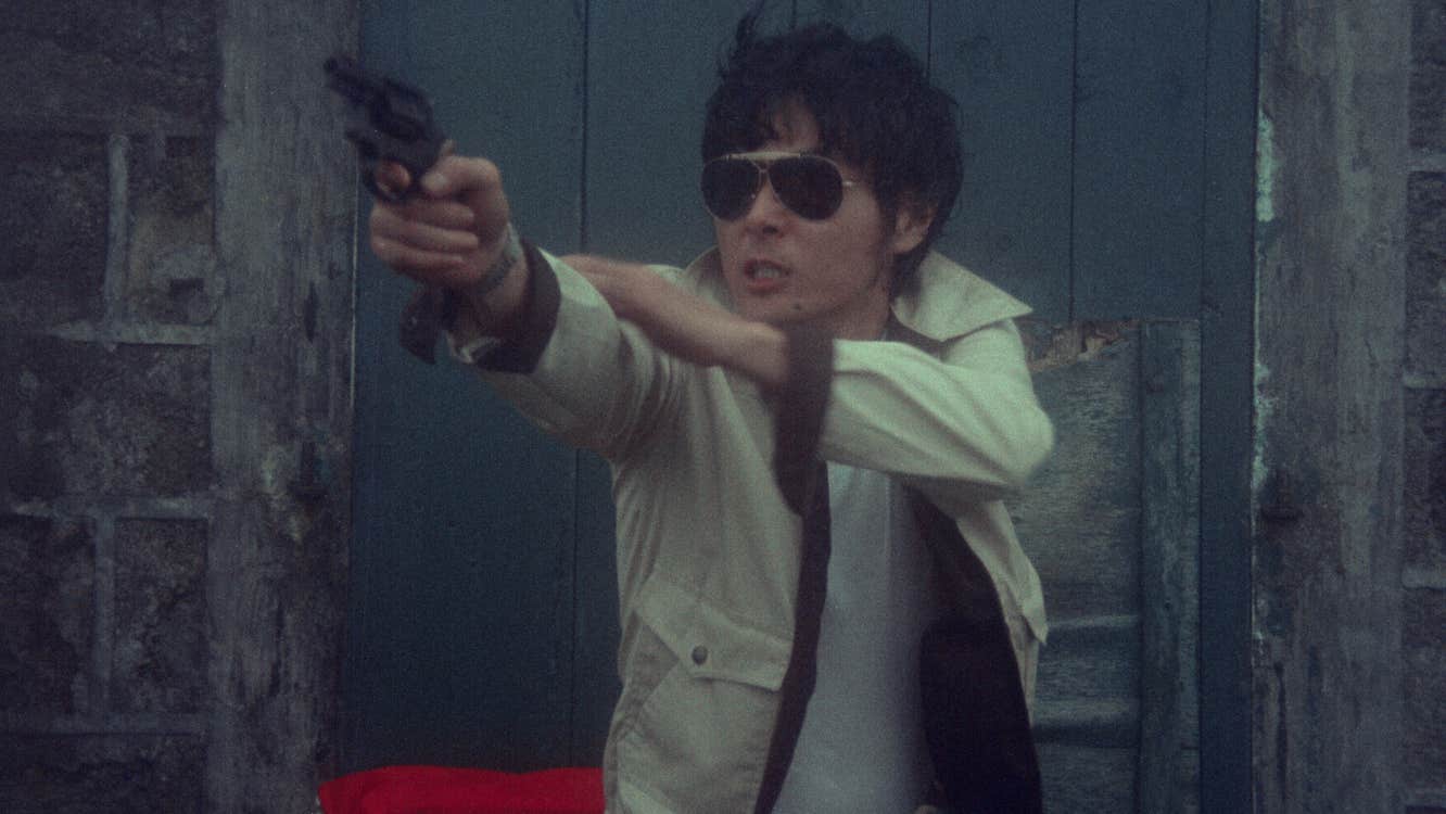 A man is pointing a pistol.