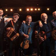 The Fureys, Farewell Tour. 5 smiling men in a line, resting on each others shoulders, holding various musical instruments.