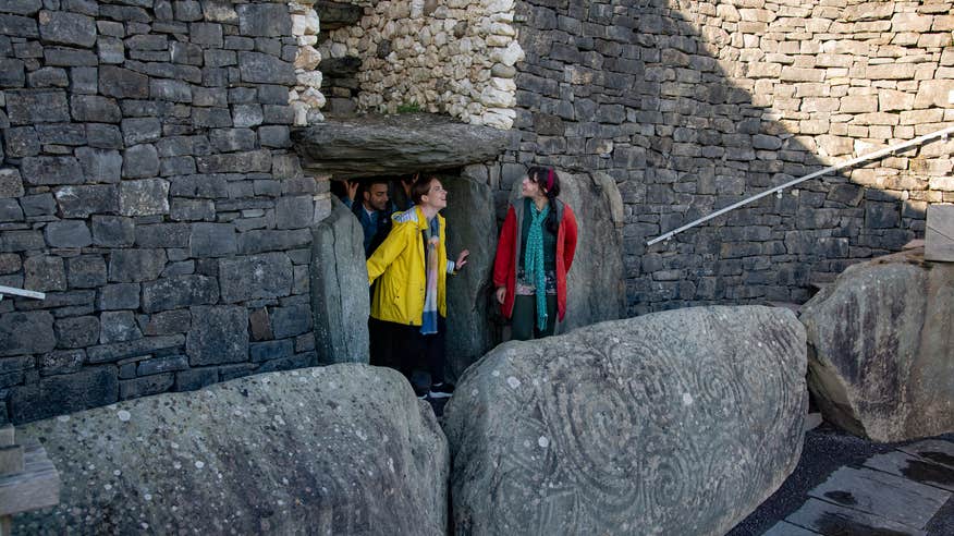 People coming out of the Newgrange passage tomb in Co Louth