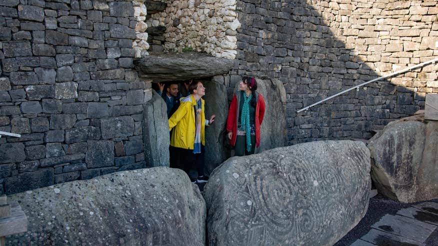 People coming out of the Newgrange passage tomb in Co Louth