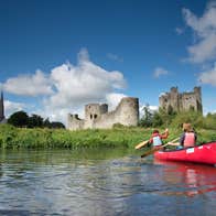 A boat paddling in a river outside Trim Castle in Meath