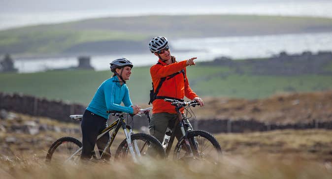 A couple cycling along the Great Western Greenway, Mayo