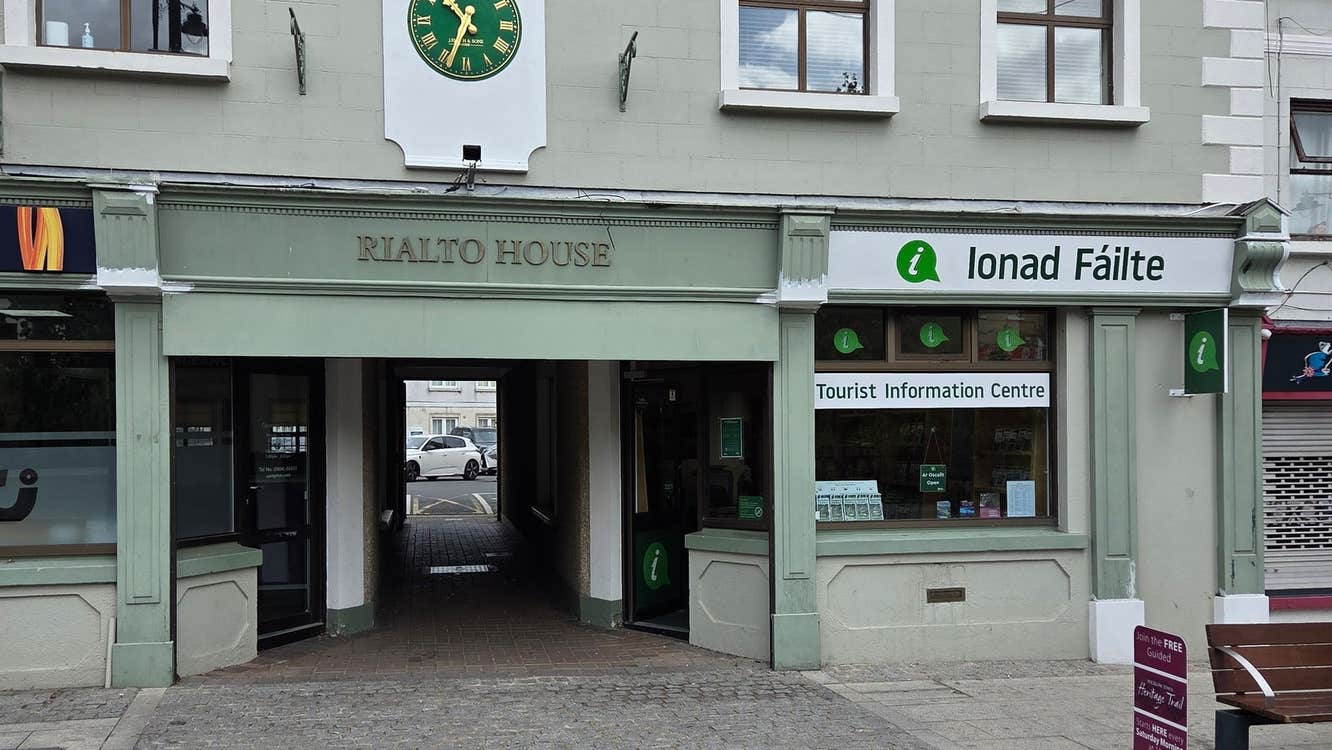 Exterior of a tourist office with branding on the window