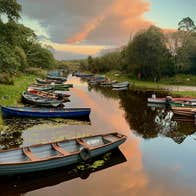 Rowing boats on a river Killarney Guided Tours