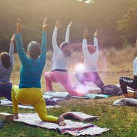 Five ladies in an outdoor setting taking part in a Pilates class