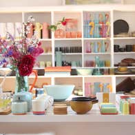 Counter and shelves in a shop full of colourful artisan ceramics