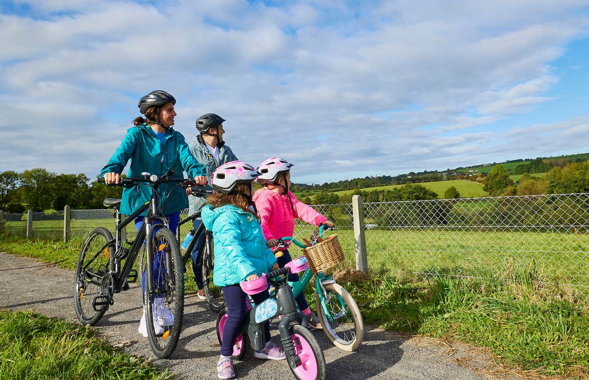Family cycling the Waterford Greenway