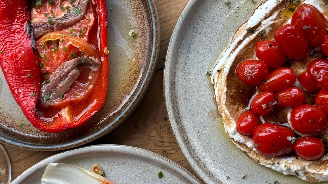 A roasted red pepper dish and a cherry tomato plate