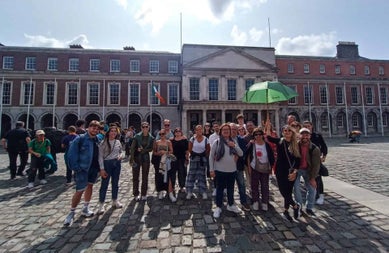 Group tour at Dublin Castle. One of the group is holding a green umbrella